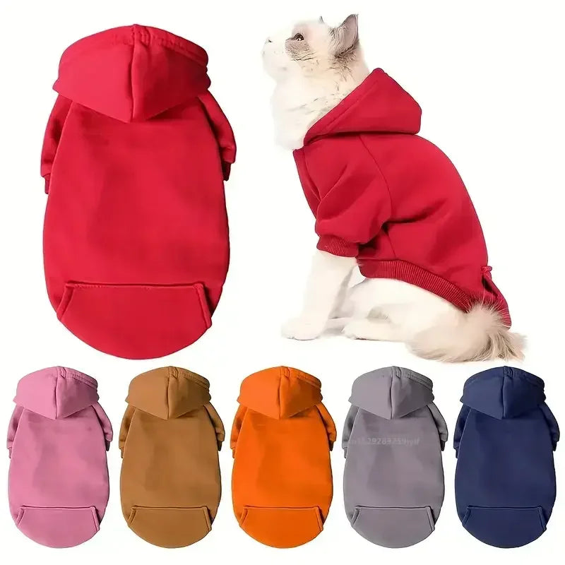 A pet hoodie shown on a white cat, with the back view on the left and a color options row along the bottom. The main featured color is bright red, with additional options in pink, tan, orange, gray, and navy.